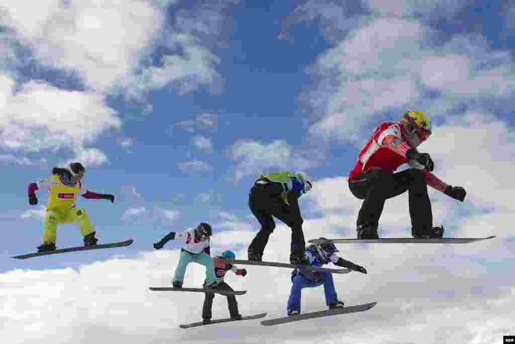 Riders compete in the final of the women&#39;s Snowboard Cross World Cup race in Veysonnaz, Switzerland, on January 22. The contest was won by Lindsey Jacobellis of the United States. (epa/Jean-Christophe Bott)