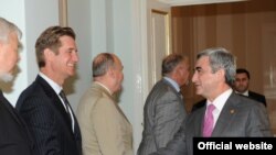 Armenian President Serzh Sarkisian (right) greets U.S. Deputy Assistant Secretary of State Matthew Bryza in Yerevan.