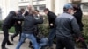 Ukraine -- Pro-Russian "self-defence" activists use a bat and a whip to beat a pro-Ukrainian supporter during clashes in Sevastopol, March 9, 2014