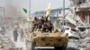 File photo - Syrian Democratic Forces (SDF) fighters ride atop of military vehicle as they celebrate victory in Raqqa, Syria, October 17, 2017.