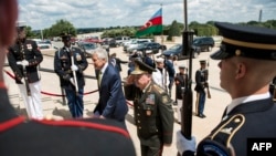 U.S. Secretary of Defense Chuck Hagel (left) and Azerbaijani Defense Minister Colonel General Safar Abiyev walk to the Pentagon during an honor cordon in Washington on August 5.