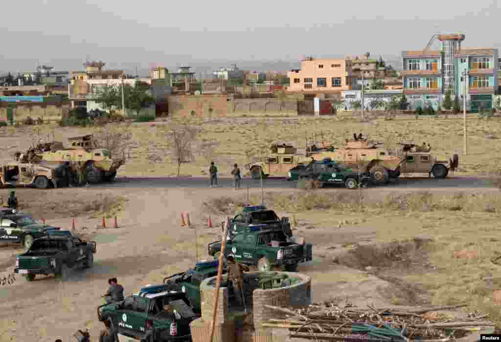 Afghan security forces take positions during a gunbattle in Kunduz city on September 29.