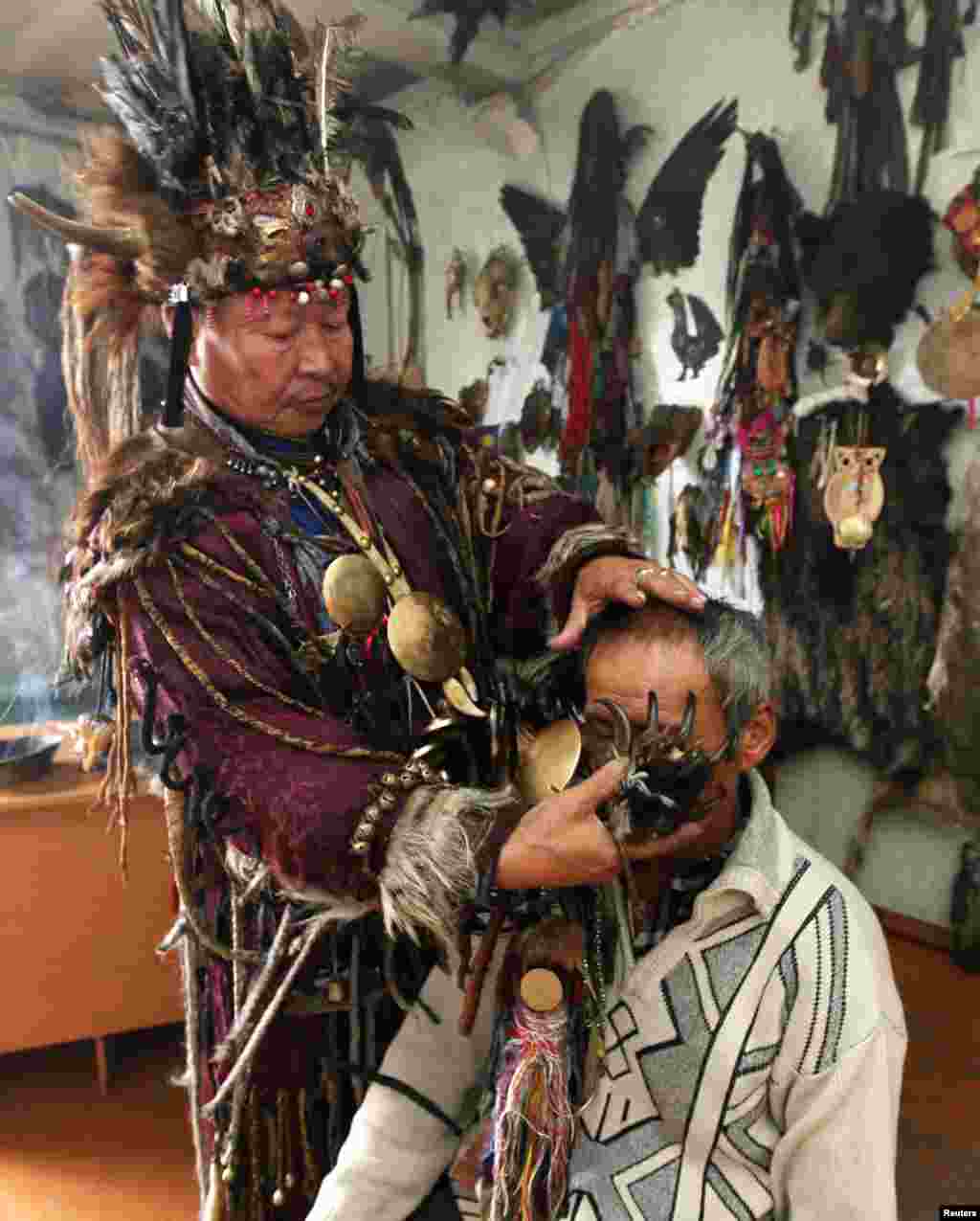 Shaman Kara-ool Dopchun-ool uses a bear claw during a ritual to cure a man of asthma and liver disease. In an interview with The Siberian Times, the shaman explained: "We don't set prices for our services.... People give us as much as they can. If a man is poor and can't give anything, he will still get help."