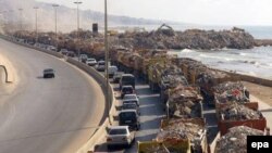 Trucks loaded with rubble from buildings, that were demolished during the 2006 war between Israel Hezbollah, transport their cargo near the southern suburbs of Beirut, 31Aug2006