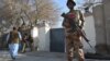 A Pakistani security personnel stands guard during the Christmas Day mass in Quetta on December 25 following a suicide bombing several weeks before.