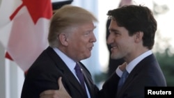 Canadian Prime Minister Justin Trudeau (right) is greeted by U.S. President Donald Trump prior to their talks at the White House in Washington on February 13. 