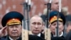 Russian President Vladimir Putin watches honor guards pass as he attends a wreath-laying ceremony to mark the Defender of the Fatherland Day at the Tomb of the Unknown Soldier by the Kremlin wall in central Moscow in February 2016.