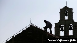 Ilustrativna fotografija: Crna Gora - radnik popravlja krov crkve Svete Nedjelje na crnogorskom primorju, mart 2017. 