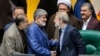 Iranian Parliament speaker Ali Larijani (2nd R) shaking hand with his second deputy Ali Motahari, May 31, 2017.