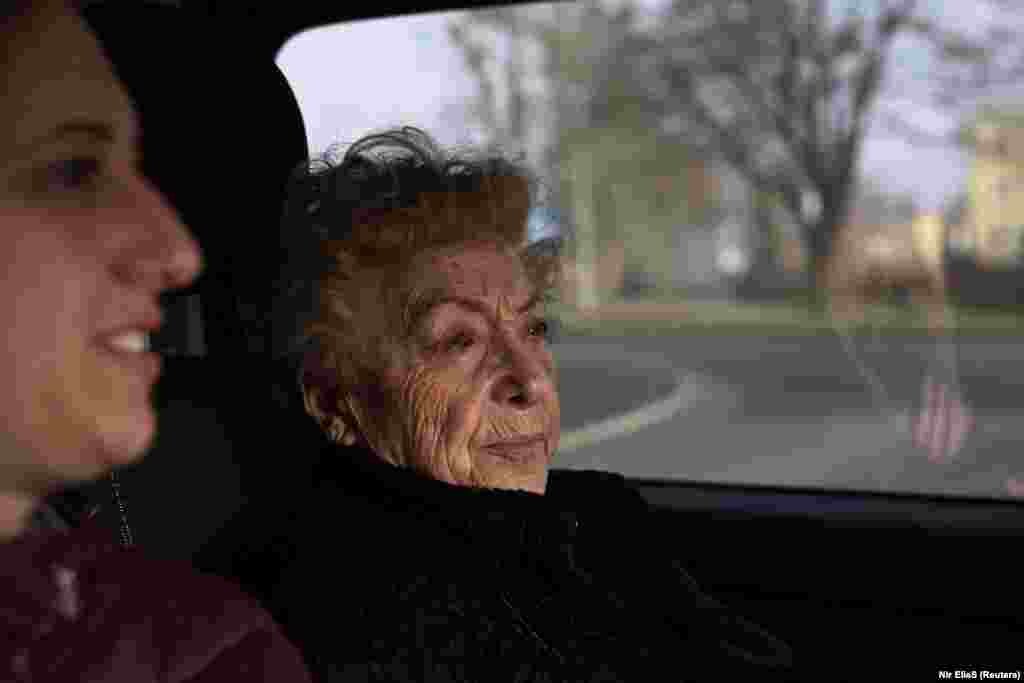 Jona Laks sits in a car next to her granddaughter, Lee Aldar as they travel from Krakow to visit the Auschwitz death camp, Poland January 26, 2020. As the vehicle neared the camp, Laks recalled her first moments there. &ldquo;It looked as if it was the end of the world, that everything is dark, cruel, unexplainable, inexplicable,&rdquo; she said.