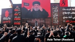 Lebanon's Hezbollah leader Sayyed Hassan Nasrallah gestures as he addresses his supporters via a screen during last day of Ashura, in Beirut, Lebanon September 20, 2018