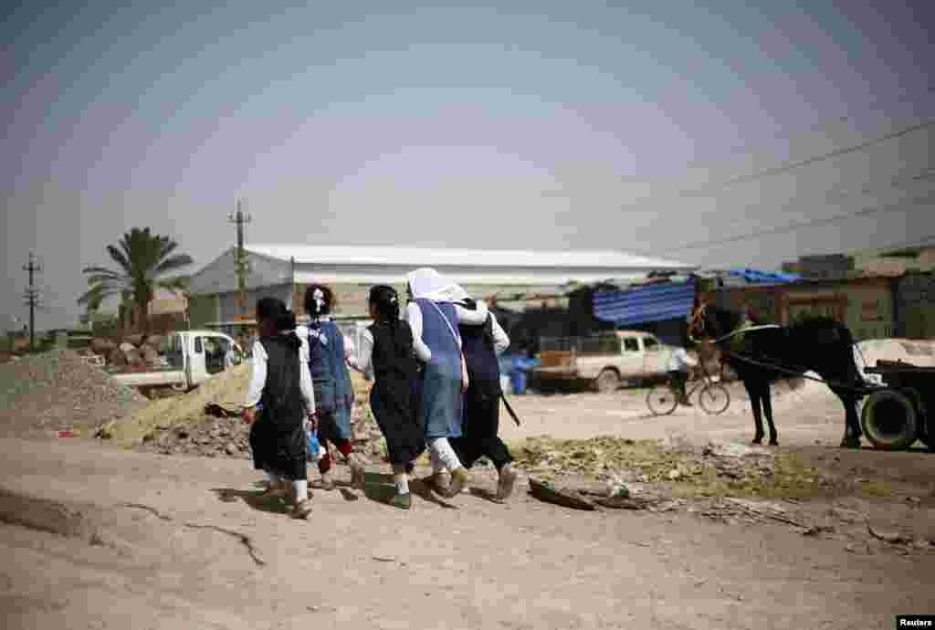 Girls walk home from school in the Al-Fdhiliya district of eastern Baghdad.