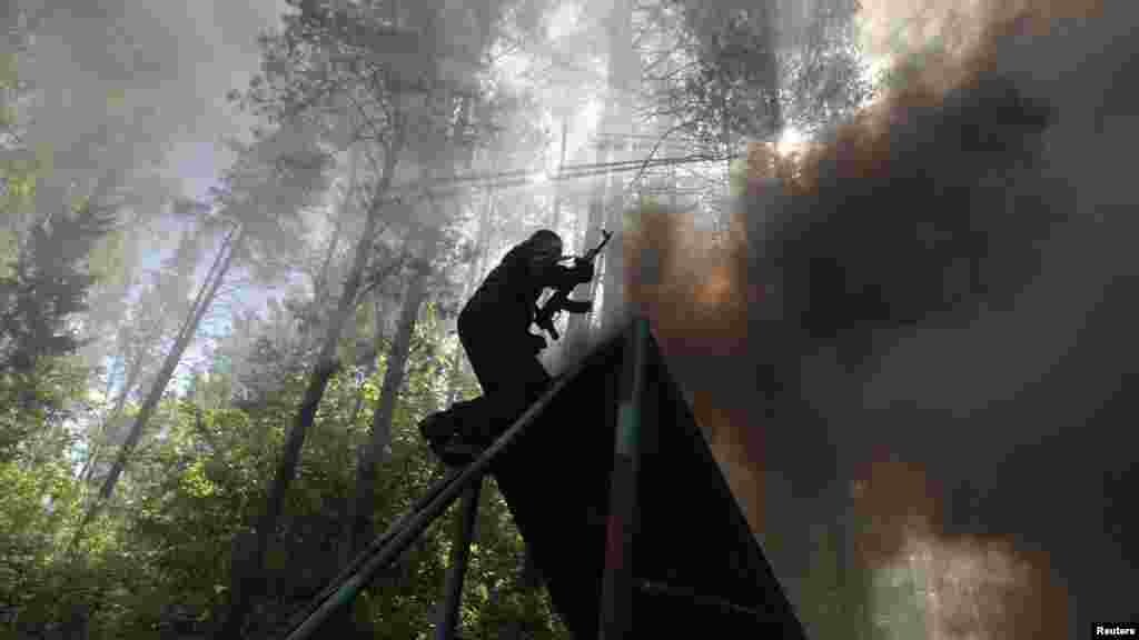 A Belarusian serviceman from a special Interior Ministry unit takes part in training exercises near the village of Volovshchina on May 22. (Reuters/Vasily Fedosenko)