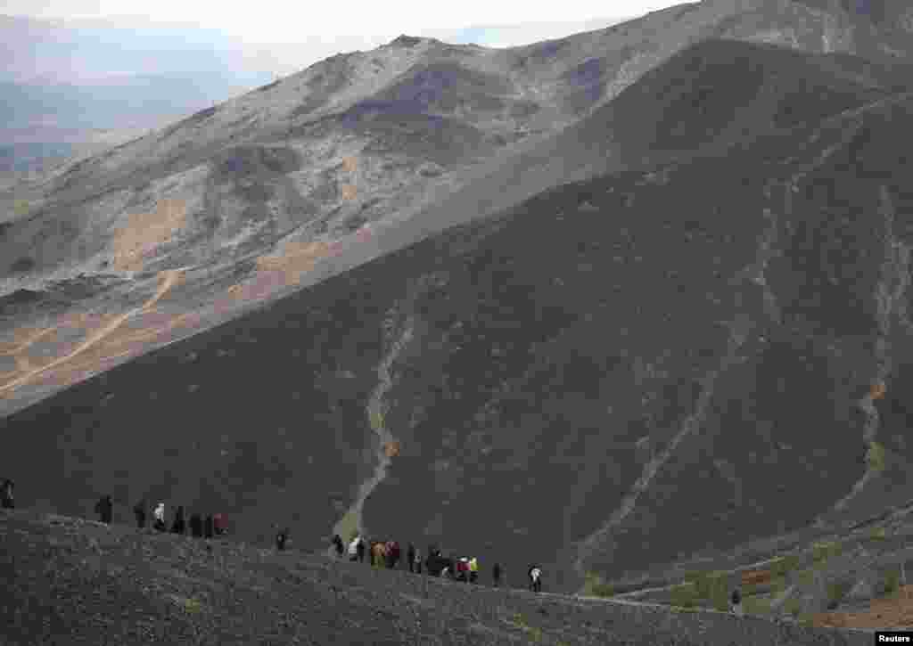 Orthodox believers follow clergy carrying religious icons and crosses during a procession in the hills above the mining town of Karabash in Russia&#39;s Ural Mountains. Locals walked some 22 kilometers as part of an annual tradition, stopping to pray at various sites near the town. (Reuters/Igor Lagunov)