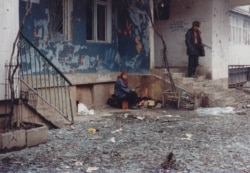 Residents venture out near Lenin Avenue during a lull in the bombing.