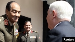 Egypt -- Chairman of the Supreme Council of Armed Forces Mohamed Hussein Tantawi (L) greets US Defense Secretary Robert Gates at the Defense Ministry in Cairo, 24Mar2011