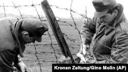 HUNGARY – Hungarian border guards cut through the barbed wire frontier with Austria and the Free West near Hegyeshalom some 50 kilometers east of Vienna on May 2, 1989.