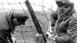 HUNGARY – Hungarian border guards cut through the barbed wire frontier with Austria and the Free West near Hegyeshalom some 50 kilometers east of Vienna on May 2, 1989.