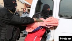 Armenia - Security forces detain a woman in a raid on a house in Yerevan's Nork district, 25Nov2015.