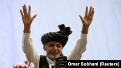 Afghan presidential candidate Ashraf Ghani gestures during his election campaign rally in Kabul on September 13.