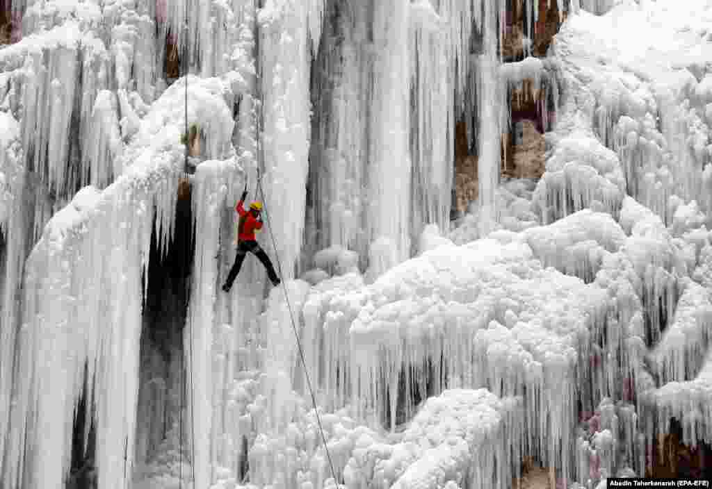 An Iranian climber scales an ice cliff and frozen waterfall at the Meygun ice-climbing club, northeast of the capital Tehran. (epa-EFE/Abedin Taherkenareh)