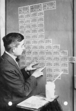 A German man using worthless banknotes for wallpaper in 1923.