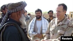 Chairman of the Joint Chiefs of Staff Admiral Mike Mullen meets with an Afghan villager in Marjah.