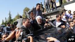Rohani waving to supporters after arriving in Tehran last month following his ice-breaking trip to New York.