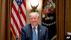 President Donald Trump smiles during a luncheon with members of the United Nations Security Council in the Cabinet Room at the White House in Washington, Thursday, Dec. 5, 2019. (AP Photo/Andrew Harnik)