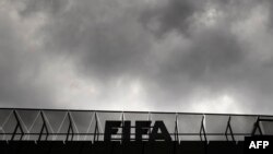 A logo of the FIFA is seen at the top of its headquarters on May 27, 2015 in Zurich. Swiss police raided a Zurich hotel to detain six top football officials as part of a US investigation into tens of millions of dollars of bribes paid to sport leaders, Sw