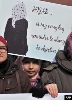 A protest participant holds up a placard in Sarajevo on February 7.