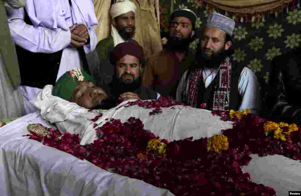 Supporters and family members of Mumtaz Qadri sit near his body after his execution in Rawalpindi, Pakistan, on February 29. Qadri killed the governor of Punjab Province over his call to reform the country's strict blasphemy laws. (Reuters/Faisal Mahmood)