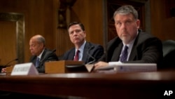 From left, Homeland Secretary Jeh Johnson, FBI Director James Comey, and Director of National Counterterrorism Center, Office of the National Intelligence, Nicholas Rasmussen, testify on Capitol Hill in Washington, Tuesday, Sept. 27, 2016, before the Sena