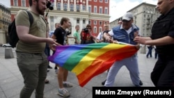 Protesters try to tear a rainbow flag during an LGBT community rally in central Moscow in May 2015. 