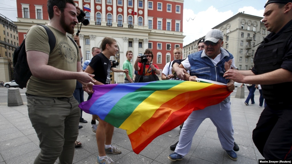 Antigay protesters attempt to remove a rainbow flag from an LGBT rally in central Moscow. (file photo)