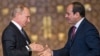 Russian President Vladimir Putin (left) prepares to shake hands with Egyptian counterpart Abdel Fattah al-Sisi after giving a press conference following their talks at the presidential palace in the capital Cairo, on December 11.