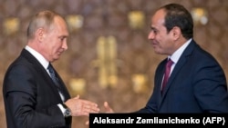 Russian President Vladimir Putin (left) prepares to shake hands with Egyptian counterpart Abdel Fattah al-Sisi after giving a press conference following their talks at the presidential palace in the capital Cairo, on December 11.