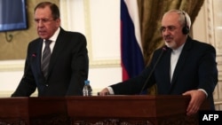 Russian Foreign Minister Sergei Lavrov (left) and his Iranian counterpart, Mohammad Javad Zarif, give a joint press conference in Tehran on December 11.