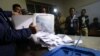 Kurdish officials empty ballots from a box after the close of polls during a disputed referendum on independence on September 25.