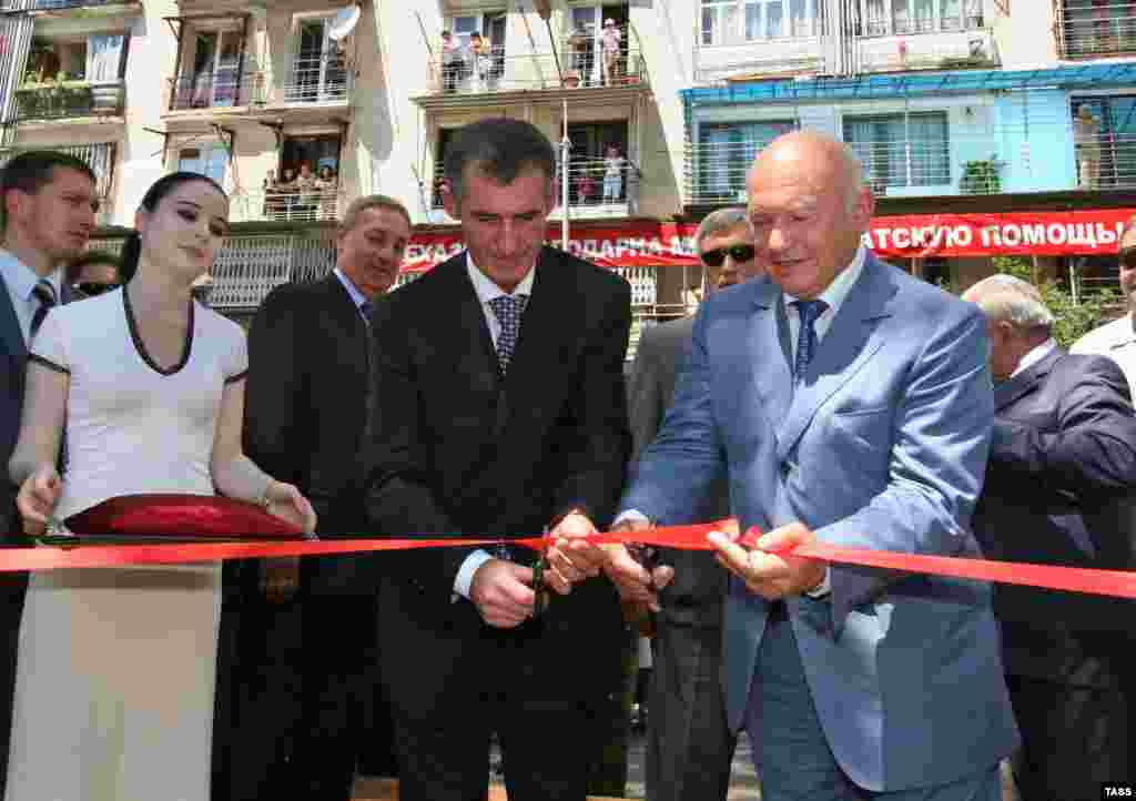Luzhkov (right) cuts the ribbon at the opening of a new cultural and business center in Moscow on July 20, 2006.&nbsp;Born in Moscow, Luzhkov&#39;s most lasting impact on the city was the metamorphic construction boom he oversaw there. High-rise office and apartment buildings came to pepper the skyline, towering over new hotels, shopping malls, and cultural objects that drew both scorn and admiration from Muscovites.