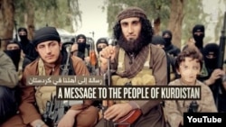 A capture of Kurdish Islamic State (IS) militant Abu Khattab al-Kurdi and his young son (pixelated) from a video purportedly by militant group Islamic State that concludes with the murder of a Kurdish-speaking captive.