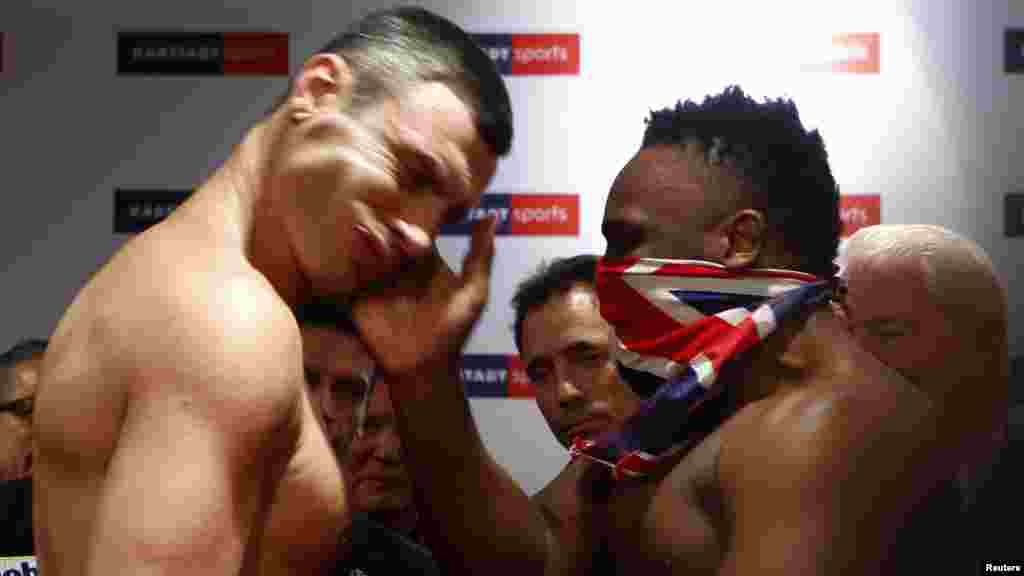 British boxer Dereck Chisora (right) slaps the face of Ukrainian heavyweight WBC boxing champion Vitali Klitschko as they stare each other down after the official weigh-in in Munich. (Reuters/Michael Dalder)