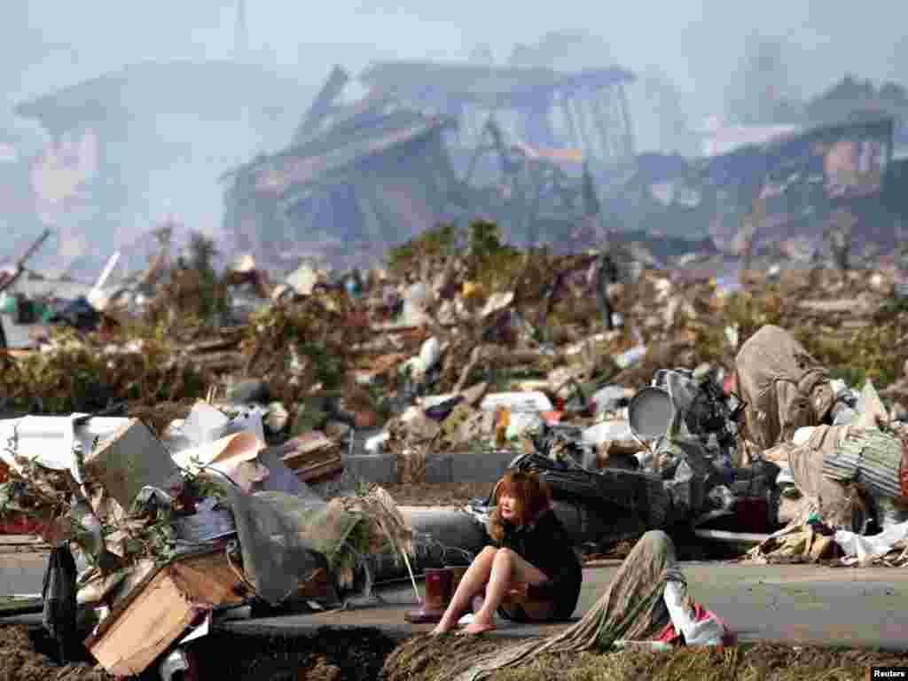 A woman cries in the destroyed city of Natori, Japan, two days after an earthquake and tsunami left some 23,000 dead or missing. (Reuters/Asahi Shimbun)