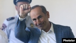 Former Armenian President Robert Kocharian greets supporters during his trial in Yerevan on May 15. 