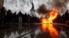 A trashcan burns on Place de la Republique as students demonstrate against the increase of the subscription fees for foreign students in Paris on December 7. (EPA-EFE/Ian Langsdon)