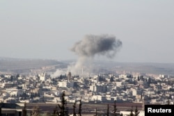 Smoke rises after air strikes by Syrian government forces in Anadan city, about 10 kilometers away from the towns of Nubul and Zahraa, in the northern Aleppo countryside on February 3.