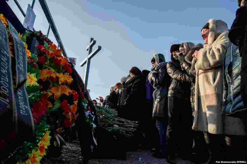 Friends and relatives mourn in front of a memorial for 30 mine workers killed in explosions at the Severnaya coal mine. The deadly blasts on February 25 prompted the rescue operations, during which another blast killed members of the emergency team. 