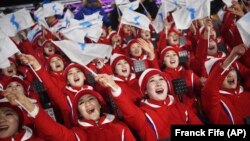 Participants wave flags of the combined Koreas before the opening ceremony of the 2018 Winter Olympics in Pyeongchang on February 9. 