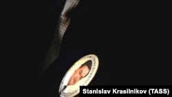 A woman wears a badge bearing a portrait of Sergei Magnitsky during a commemorative event for him in Moscow in April 2013.