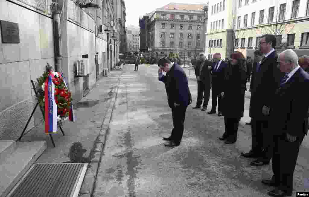 Serbian Prime Minister Ivica Dacic (center) and members of the government pay their respects on March 12, 2013, in front of the Serbian government building where Djindjic was assassinated 10 years ago in Belgrade. (Reuters/Djordje Kojadinovic)